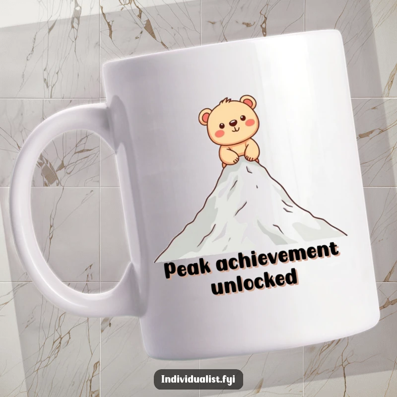 Funny bear cub mug showing a happy cub scaling a small mountain peak with determination and a wide smile, perfect for gift-givers.