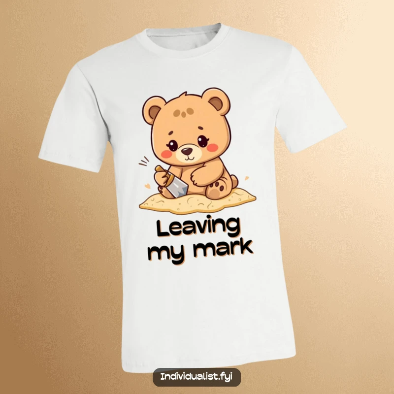 Funny, determined bear character intently focused on creating an elaborate pattern in the sand on this artistic t-shirt.
