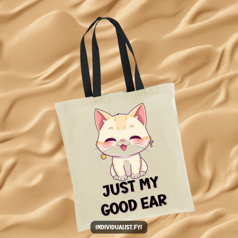 Funny tote bag showcasing a giggling cat wearing a single, large, shiny sparkly earring, looking amused and fashionable.